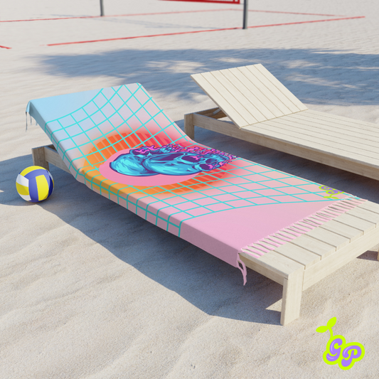 Pastel grid towel with melting blue skulls draped on a beach chair next to a volleyball, showcasing its versatile use for beach days and summer festivals.