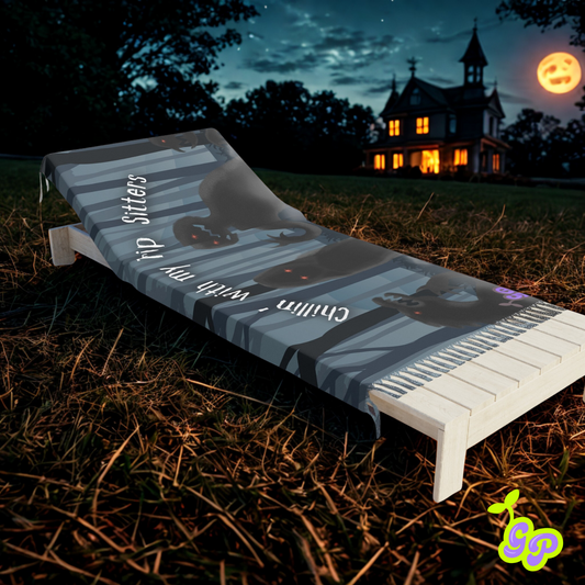 Ground Pash pashmina with spooky shadow creatures and "Chillin’ with my Trip Sitters" text, displayed on a lounge chair in front of a haunted house under a full moon.