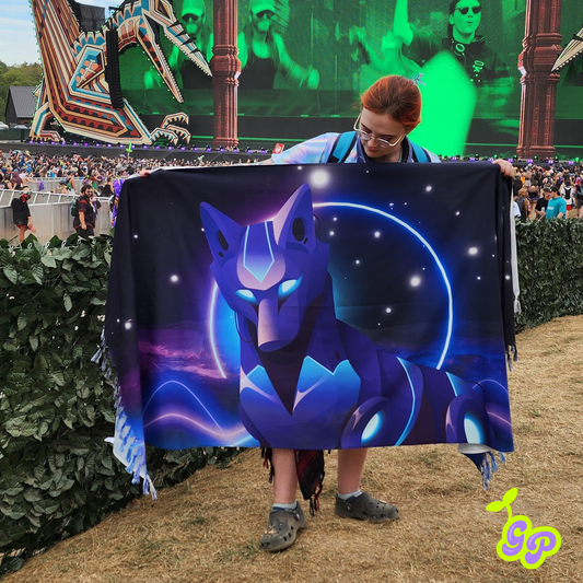 Female rave-goer holding the neon cyber wolf rave pashmina while standing in front of Lost Lands music festival main stage in order to demonstrate size. 