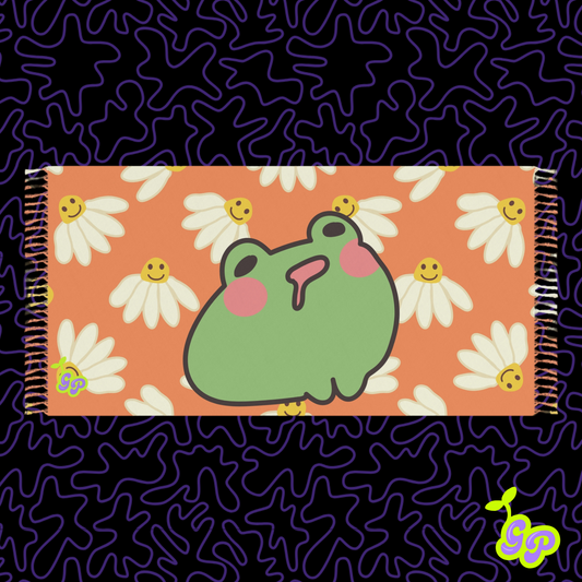Cute cartoon frog with pink cheeks surrounded by smiling daisies on an orange background, displayed on a pashmina 