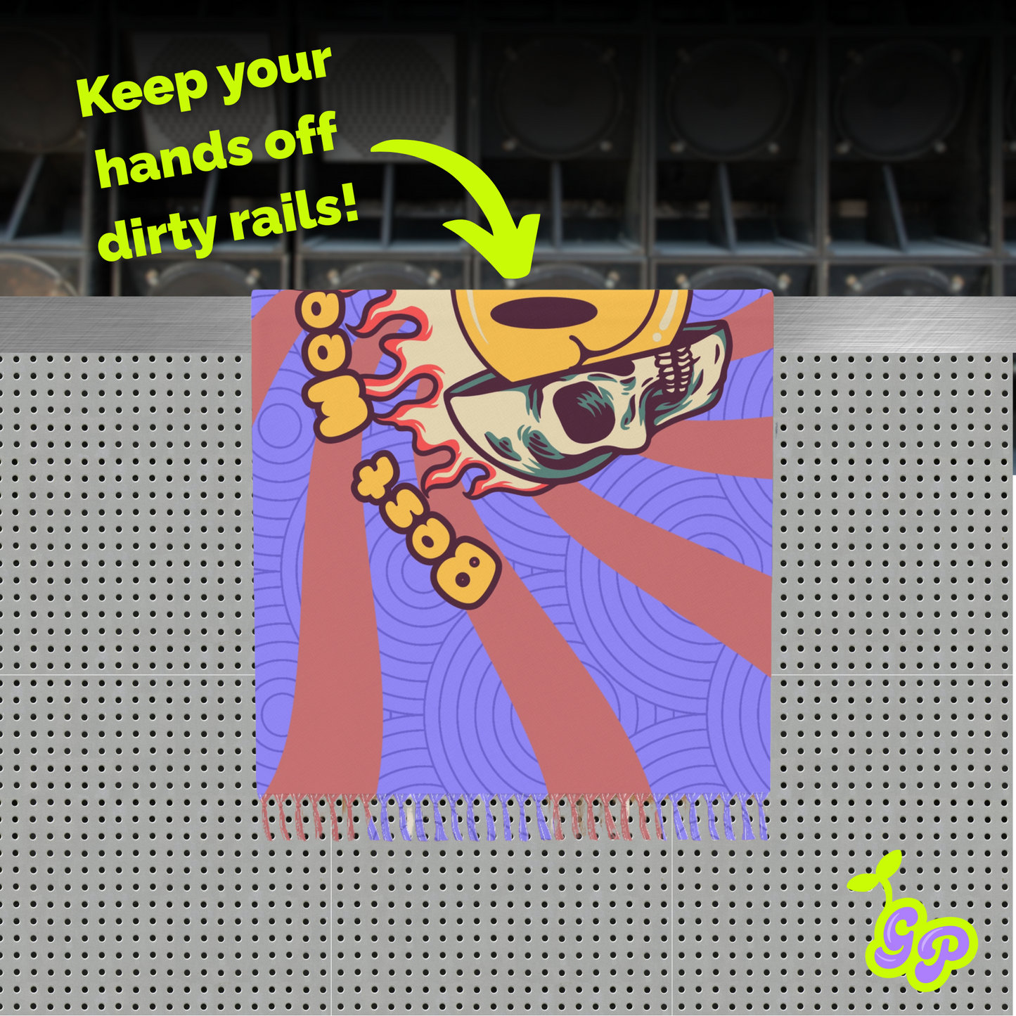 Colorful rave pashmina used as a barrier on dirty rails with bold skull print, neon text, and speakers in the background.